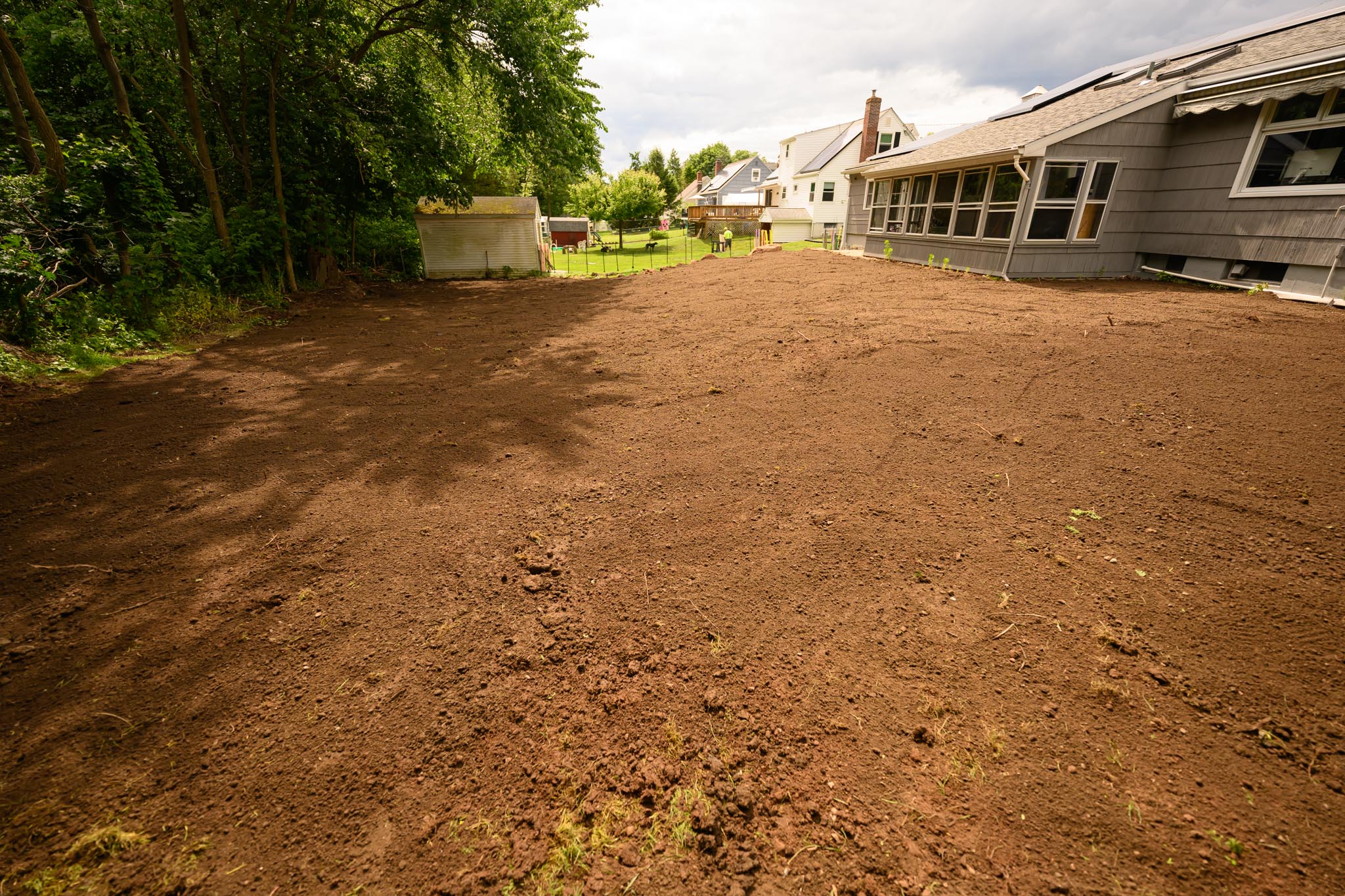After pool removal in Bristol CT showing the yard graded into a wide open usable space