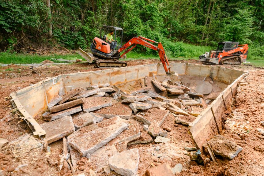 Glastonbury CT pool removal with concrete slabs broken and staged for clean grading