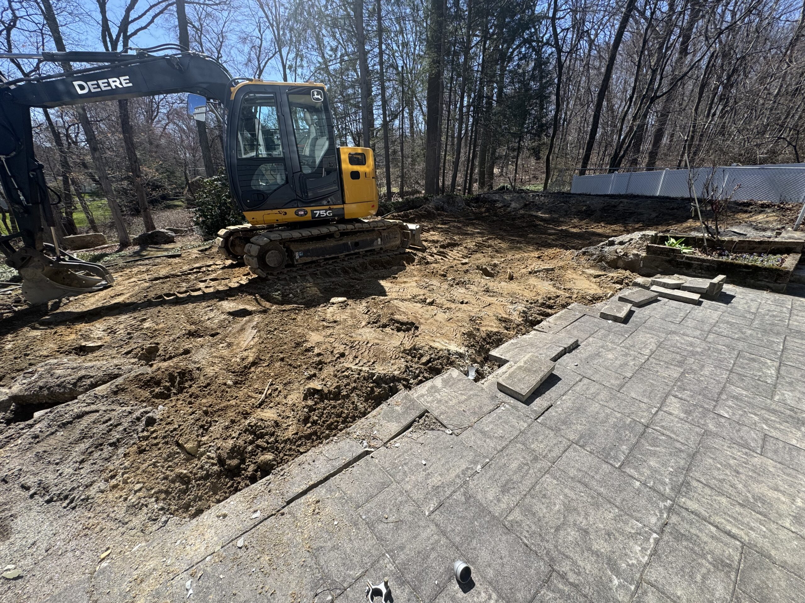 Excavator on a Grillo pool removal jobsite